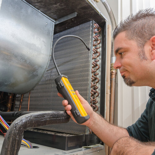 technician providing emergency air conditioner repair