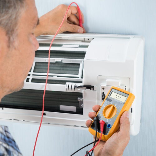 technician checking an air conditioning system